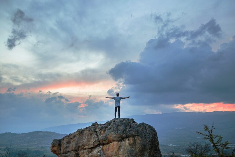 Men-On-Top-Of-A-Rock-Looking-At-Nature