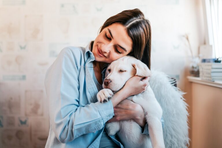 beautiful-brunette-girl-hugging-her-puppy-home-close-up