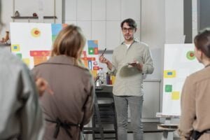 confident-teacher-painting-explaining-his-students-main-rules-professional-drawing-lesson-arts-school