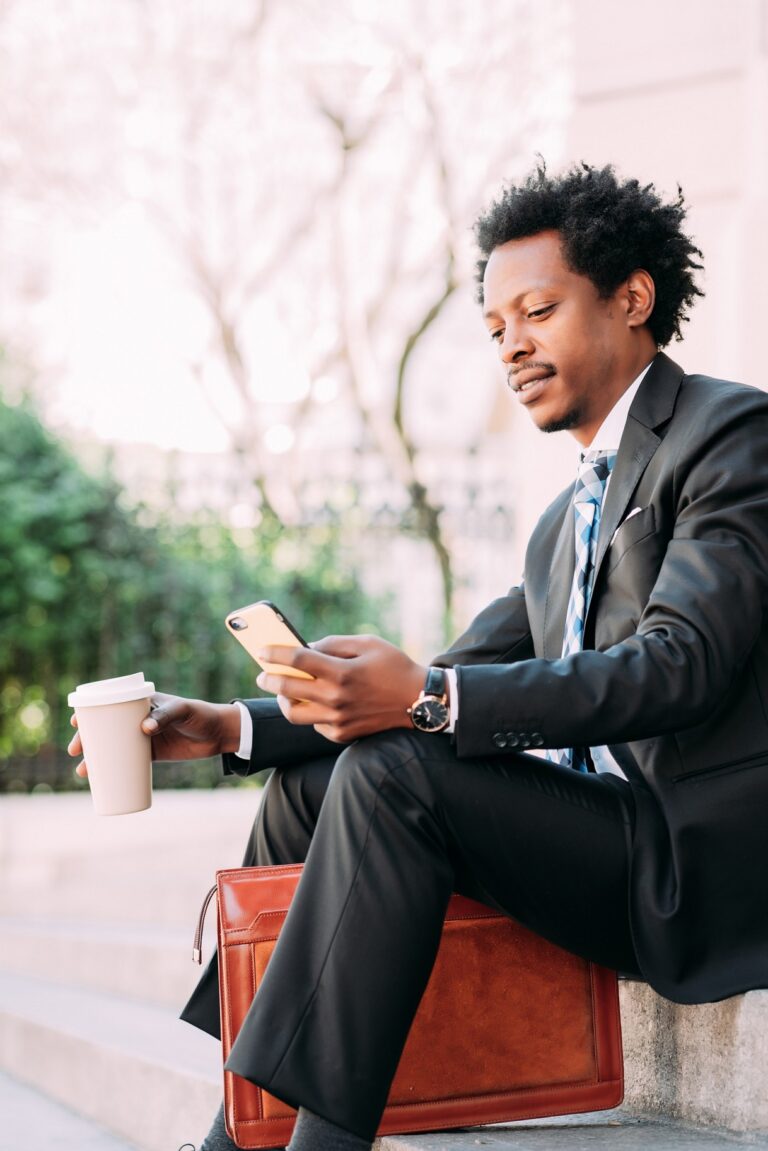 Businessman using his mobile phone outdoors.