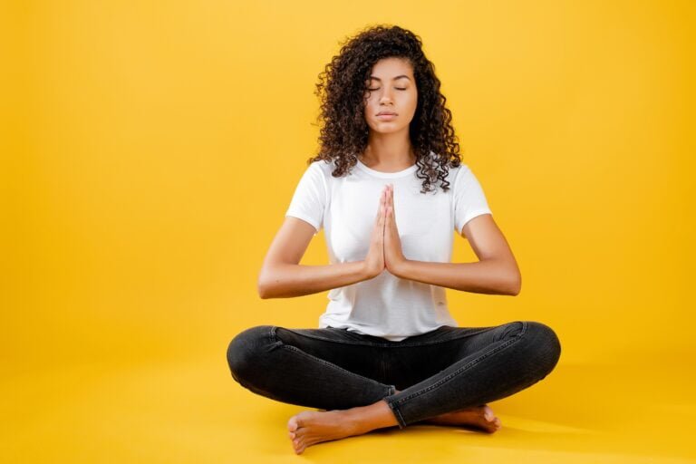 relaxed-black-woman-meditating-yoga-pose-isolated-yellow