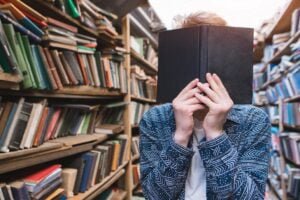 student-stands-cozy-old-public-bulletin-holds-book-front-him