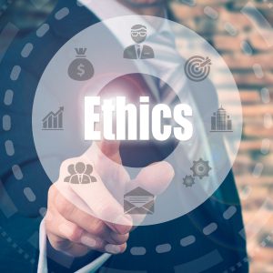 Portrait of a man pointing at Ethics sign.