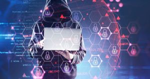 Portrait of a hacker holding a laptop.