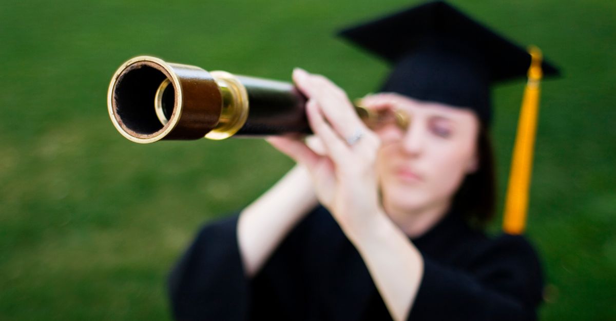 Portrait of a student looking with a telescope.