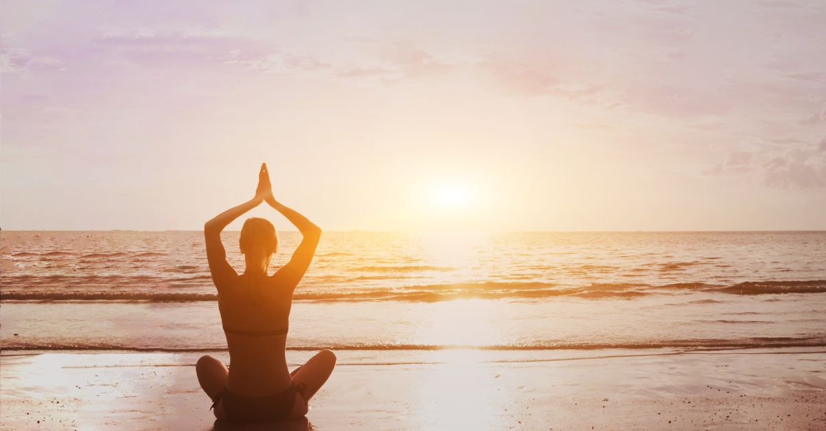 Portrait of a lady meditating at the beach