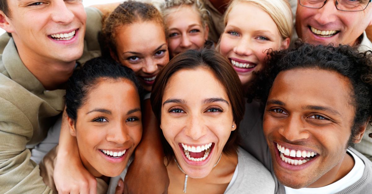 Portrait of many people smiling together.