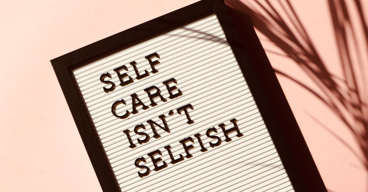 Board showing "Self care isn't selfish" slogan.