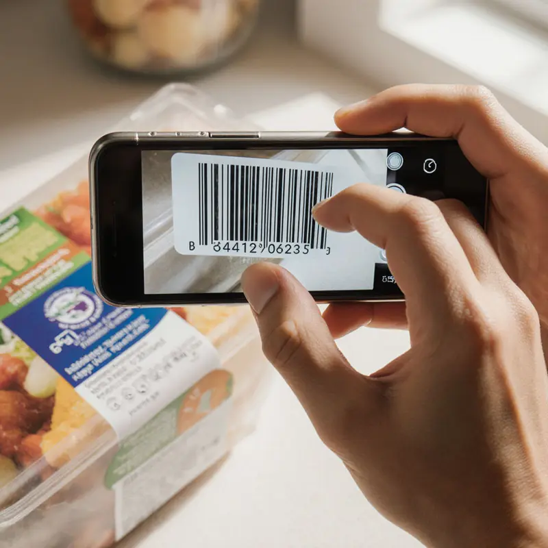Smartphone scanning a product barcode, illustrating Yuka’s initial data capture.