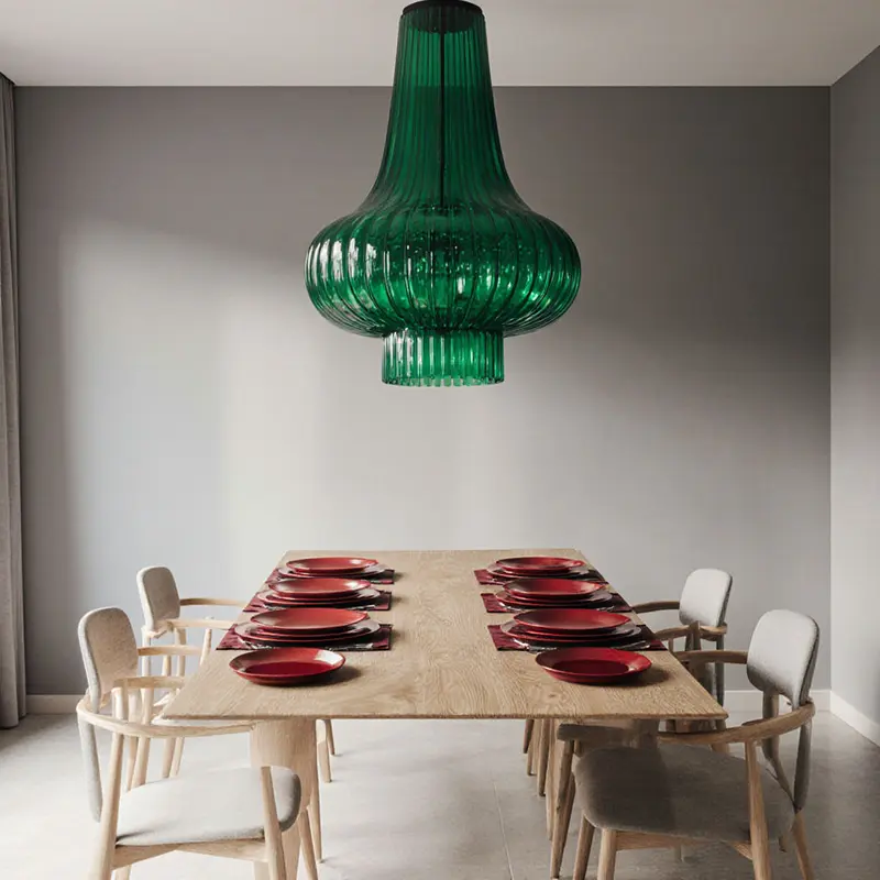 Emerald chandelier over neutral gray walls highlights jewel tones boosting bold accents.
